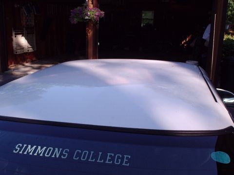 1998 Ford Taurus - The rear window of a car displays 'SIMMONS COLLEGE' text and a SuperMotors logo.