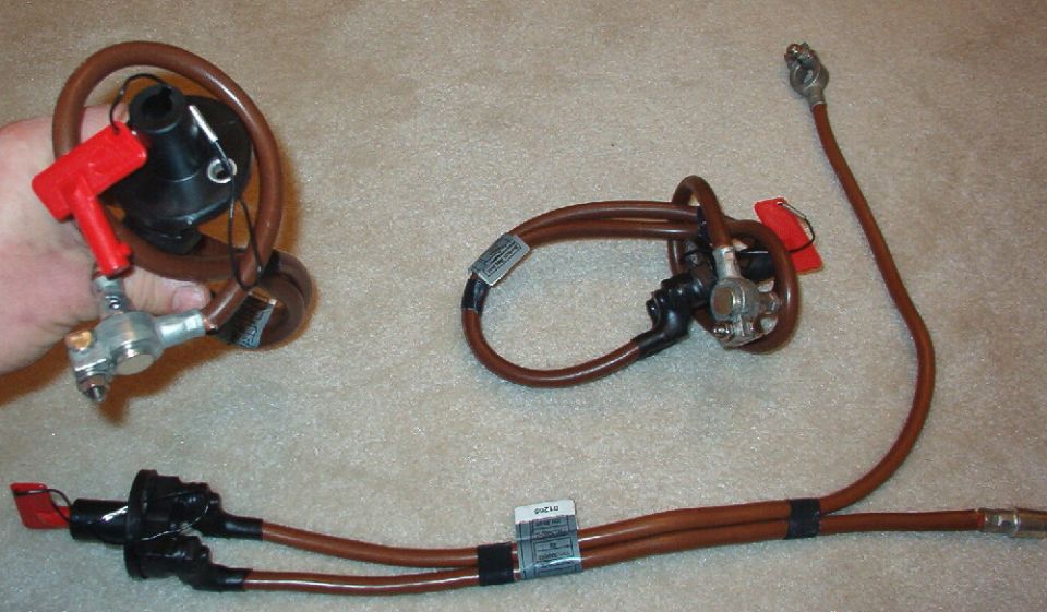 These are Hella battery switches with heavy-gauge battery wires, used on '03-04 Land Rover Range Rovers as transport cutoff switches. They're rated at 100A continuous; 1000A @12V for 10 sec. The battery terminals are unusual, but also high-quality. The wire with the post is about 17" and the other is about 28". The switch is on when the red key is inserted, pushed in, and turned to lock. The nosepiece of the switch is 1 1/4" long from the mounting face. The wires have heat-shrink wrapping at the switch terminals, but they can be removed easily, exposing posts with nuts. Here's the Hella page: http://www.hella.com.au/cgi-bin/catalogue.pl?flcmd=preview&flmaint=290