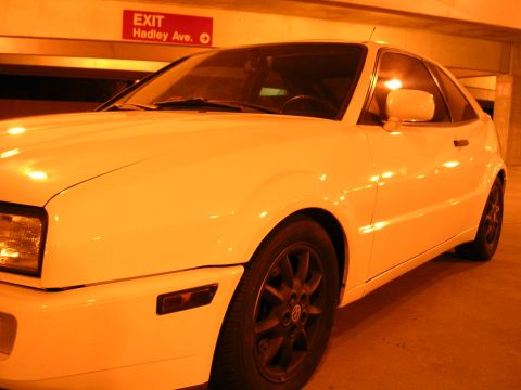 1990 Volkswagen Corrado - A white Volkswagen Corrado is shown from the front 3/4 angle in an indoor parking area.