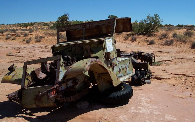 Rusted vintage vehicle chassis in desert