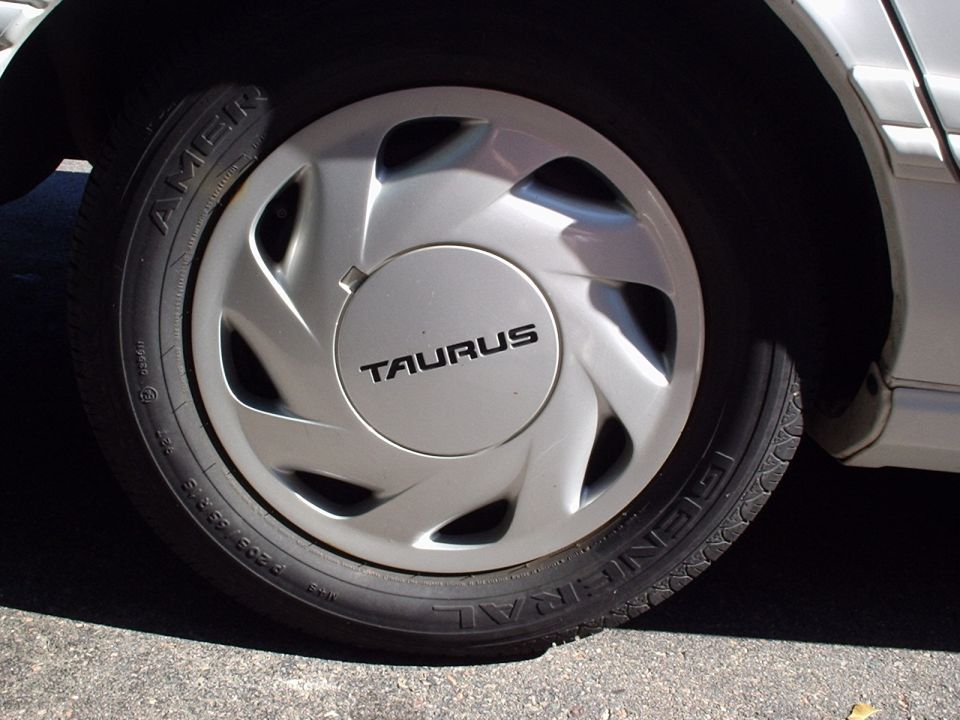 Silver TAURUS wheel cover on a General P205/65R15 tire