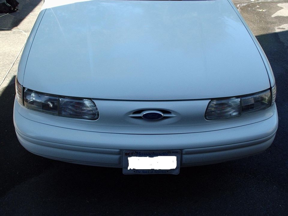 1998 Ford Taurus front view, showing headlights, grille with Ford emblem, and bumper