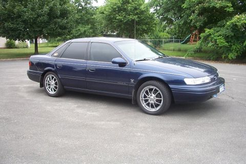1993 Ford Taurus - This sedan has a distinctive body style that suggests a model year around 1992.
