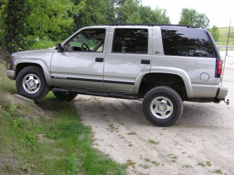 2000 Chevrolet Tahoe - This 2000 Chevrolet Tahoe is captured in a side profile while navigating an off-road terrain.
