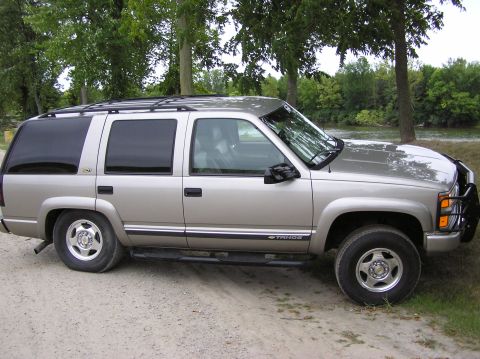 2000 Chevrolet Tahoe - Side view of a silver 2000 Chevrolet Tahoe SUV parked outdoors.