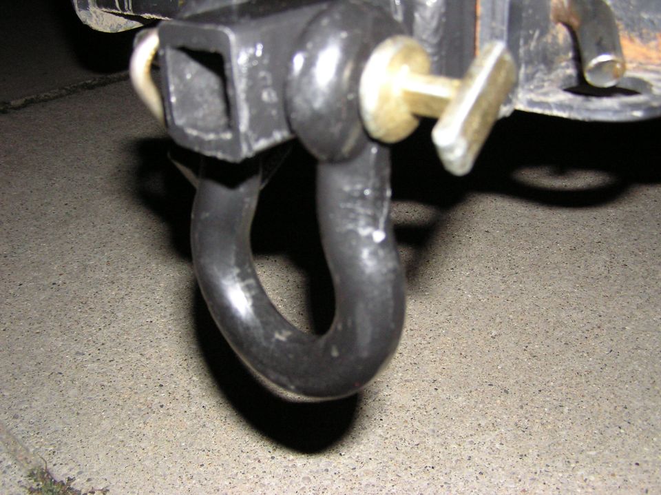 Close-up of a tow hitch shackle with a pin