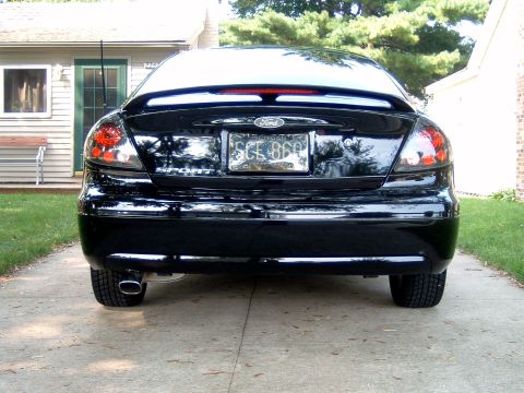 2004 Ford Taurus - Rear view of a black 2004 Ford Taurus parked in a driveway.