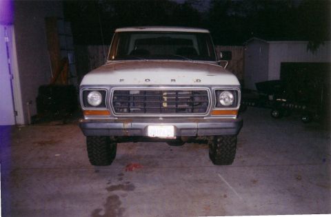 1978 Ford Bronco - This Ford truck is parked in a driveway at night, showing its front grille and headlights.