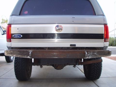 1993 Ford Bronco - Rear view of a 1993 Ford Bronco, a custom metal bumper and the Ford emblem.