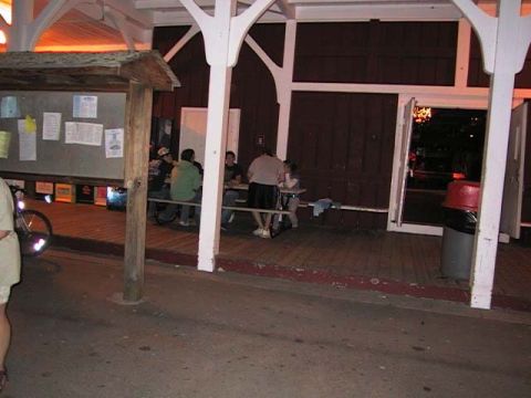 2000 Jeep Liberty - People gathered at picnic tables on a wooden deck, with a building in the background.