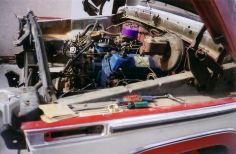 1978 Ford Bronco - Engine bay of a 1978 Ford Bronco, showing the engine and tools laid out on the fender.