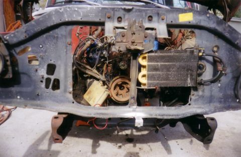 1978 Ford Bronco - The engine bay of a 1978 Ford Bronco is visible, with the engine and associated components exposed.