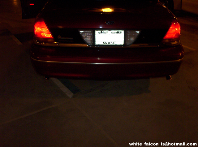 Rear of dark red sedan with Kuwait license plate