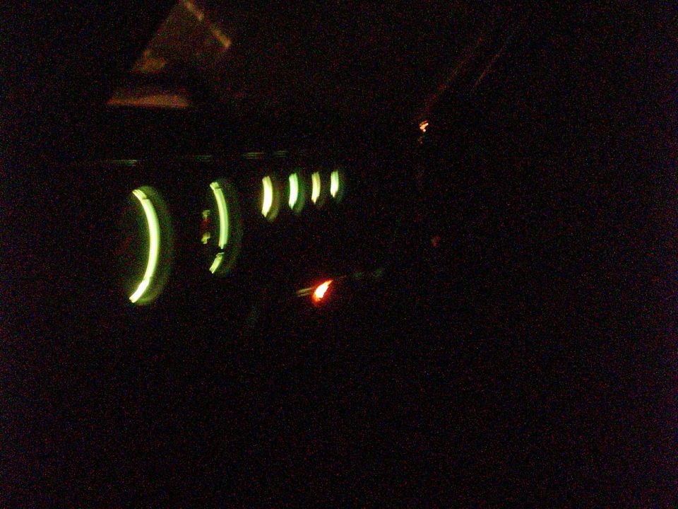 Dashboard gauges with green illumination at night