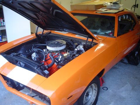 1993 Ford Taurus - Orange muscle car with hood open, revealing the engine and front end with racing stripes.