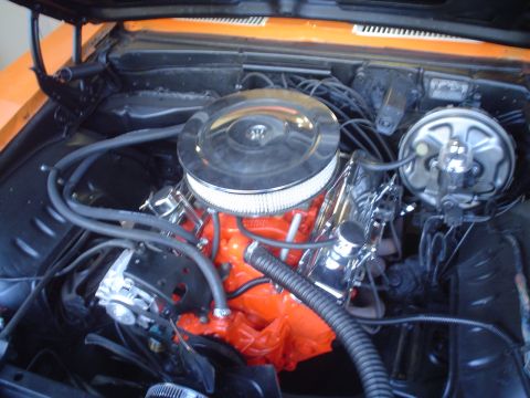 1993 Ford Taurus - Close-up view of a V8 engine, an orange block and chrome accents under the hood.