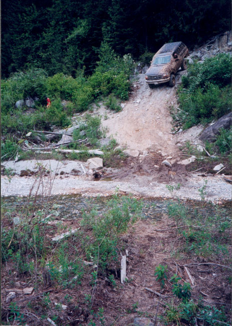 1993 Ford Bronco - A brown Ford Bronco navigates a challenging off-road incline.