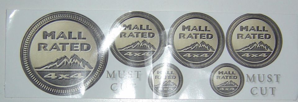 Sheet of circular decals with mountains and '4x4' text, some with 'MALL RATED' and 'MUST CUT' text