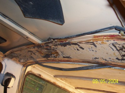 1979 Ford Bronco - The interior roofline shows significant wear and damage, with peeling paint and exposed rust.