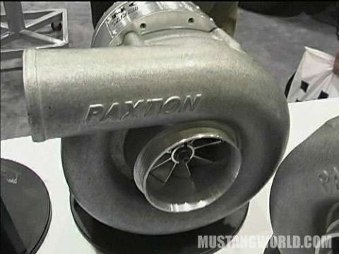 1998 Ford Crown Victoria - Paxton centrifugal supercharger sits on a display surface, the cast PAXTON name visible across its inlet tube.