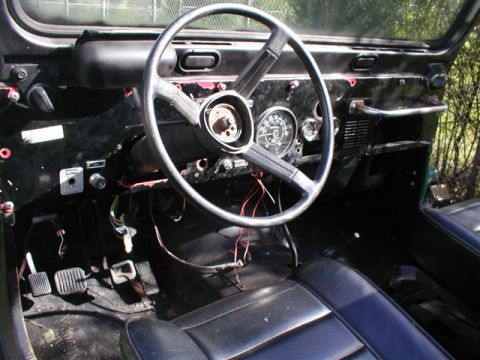1979 Ford Bronco II - Interior view of a Jeep CJ, likely from the mid-to-late 1970s, with exposed wiring and a partially disassembled dashboard.