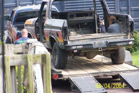 1979 Ford Bronco II - A black Ford Bronco is loaded onto a trailer, showing its rear end and the text "GOT MUD?".