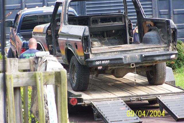 Black Ford Bronco on a trailer, rear view, with "GOT MUD?" text