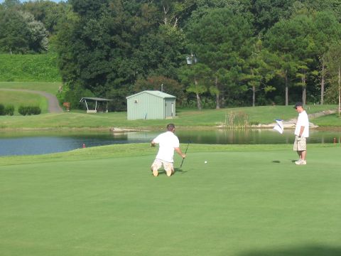 1988 Ford Bronco - Two men play golf on a course with a pond and trees; "SUPERMOTORS" logo is visible.