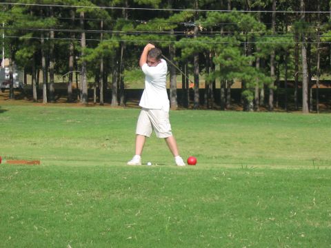 1988 Ford Bronco - A golfer prepares to strike a ball on a sunny day at the golf course.