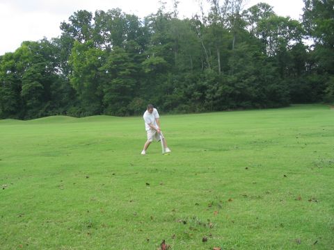 1988 Ford Bronco - Man plays golf on a sunny day with trees lining the course.