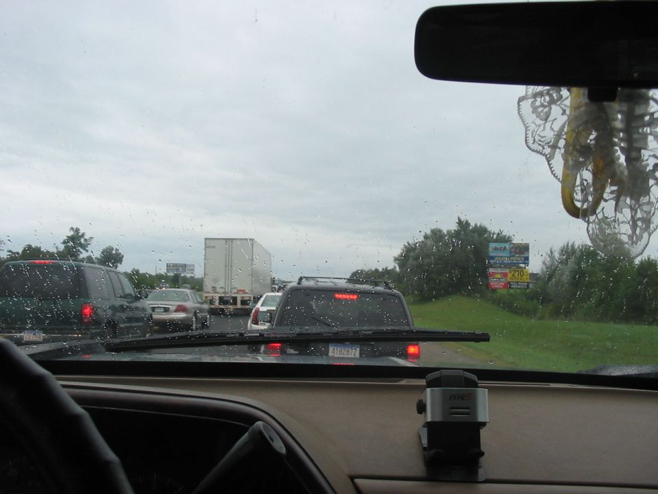 View from inside a vehicle looking at a highway traffic jam with multiple cars and a semi-truck