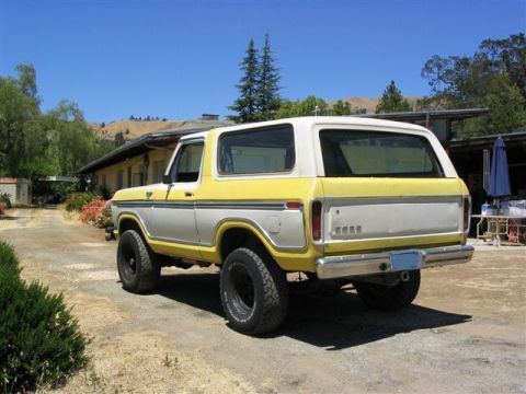 1978 Ford Bronco - This two-tone Ford Bronco is parked outside a building on a sunny day.