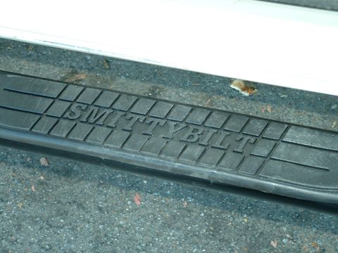 1990 Ford Bronco - The textured surface of a Smittybilt step bar is visible, mounted on a vehicle.