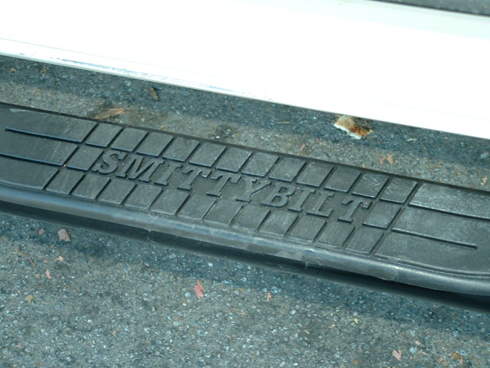 Close-up of a black Smittybilt step bar on a vehicle