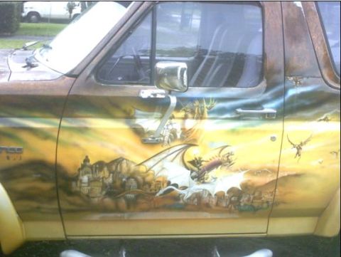 1992 Ford Bronco - This van features a detailed mural of dragons and a castle, painted on its side.