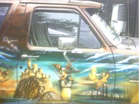 1992 Ford Bronco - Truck door features a fantasy mural with dragons and a castle. Supermotors.net logo is present.