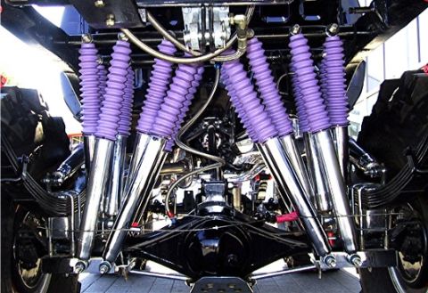 1989 Ford Bronco - Custom suspension parts are visible on the underside of a vehicle, chrome and purple components.