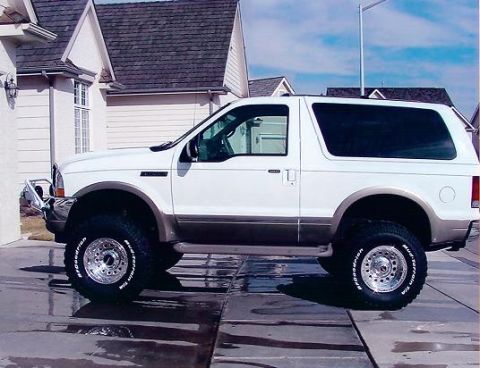 1980 Ford Bronco - This Ford Excursion SUV is shown from the side, aftermarket wheels and a two-tone paint scheme.