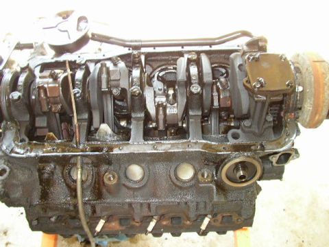 1995 Ford Bronco - Engine block with crankshaft and connecting rods exposed, showing internal components.