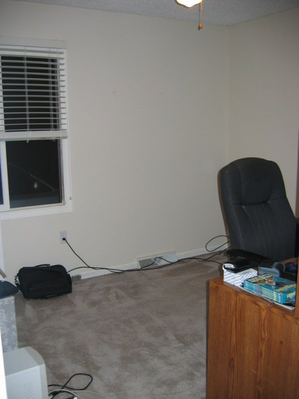 Office interior with desk, chair, window, and carpet