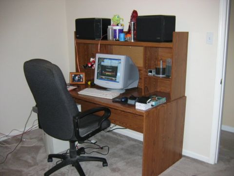 1985 Ford LTD Crown Victoria - Office desk setup with computer equipment and an office chair.