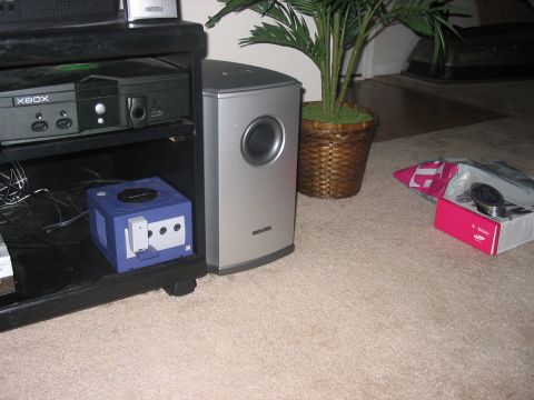 1988 Ford Bronco - An Xbox and a blue Nintendo GameCube are visible next to a silver subwoofer and a potted plant.