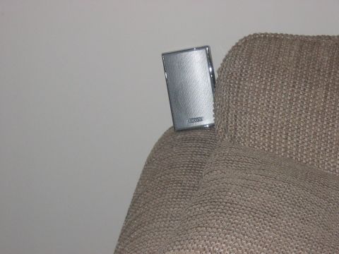 1988 Ford Bronco - A speaker is attached to a tan fabric surface, possibly a car seat or interior panel.