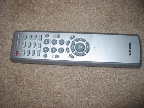 1988 Ford Bronco - A Samsung remote control is shown lying on a carpeted surface.