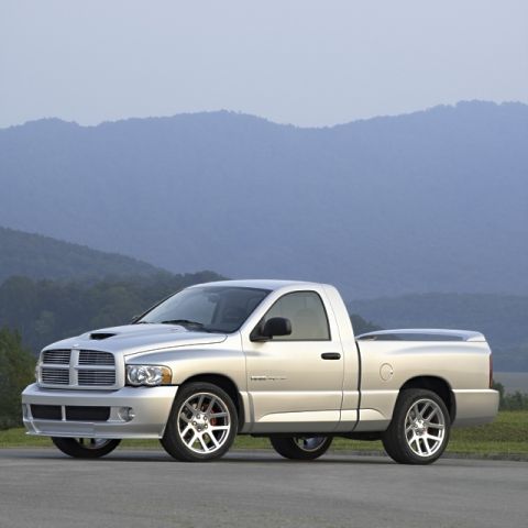 1998 Ford Taurus - Silver Dodge Ram SRT-10 pickup truck with a hood scoop and performance wheels.