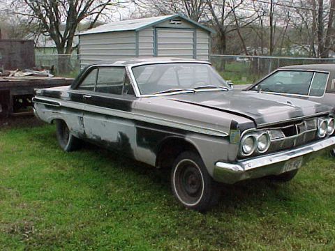1964 Mercury Comet - A 1964 Mercury Comet is seen in a grassy yard next to another vehicle and a shed.