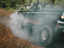 1995 Ford Bronco - An SUV drives off-road, creating a cloud of dust and smoke.