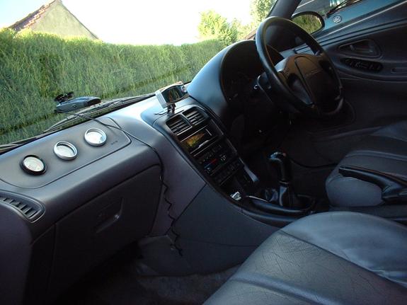 Car interior with dashboard, steering wheel, and center console