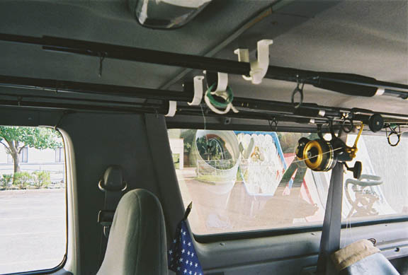 fishing rods mounted on ceiling rack inside vehicle