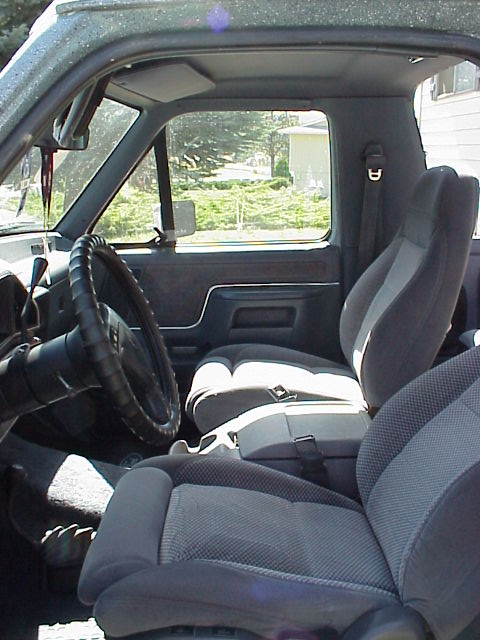 1989 Ford Bronco - Interior view of a 1989 Ford Bronco, highlighting the front seating area and dashboard.